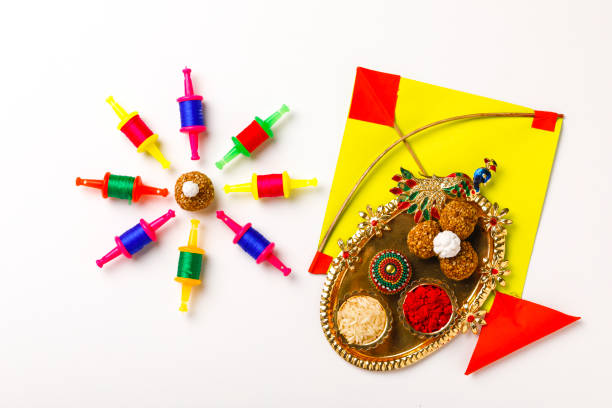 Indian festival makar sankranti concept, sesame seed ball or til ke laddo and tilgul with colorful paper kite